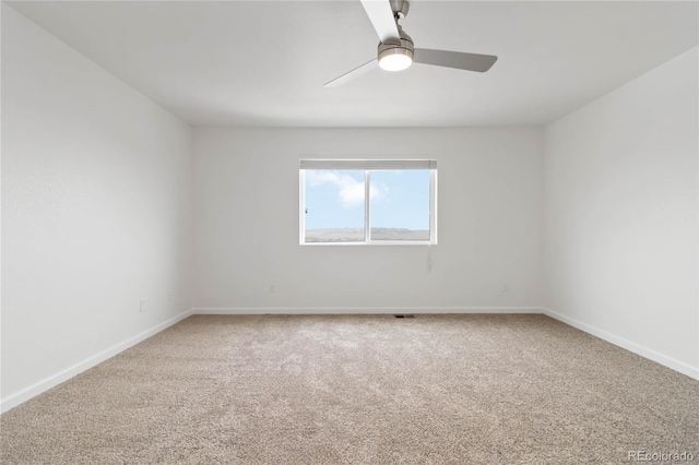 spare room with carpet floors and ceiling fan