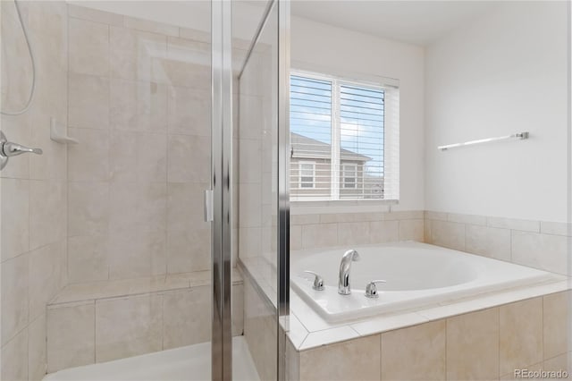 bathroom with shower with separate bathtub