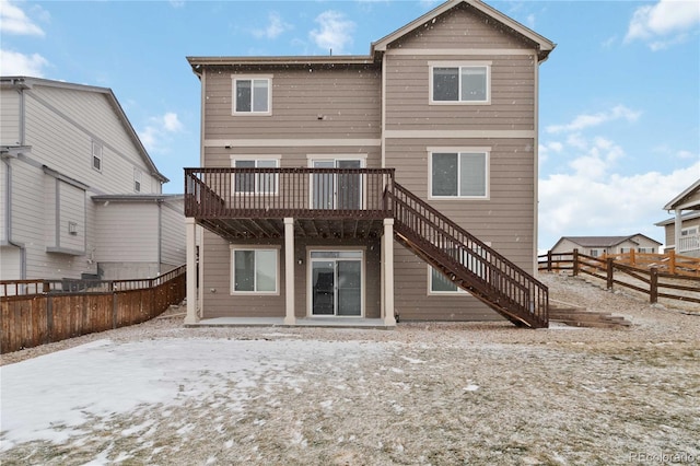 rear view of property with a wooden deck