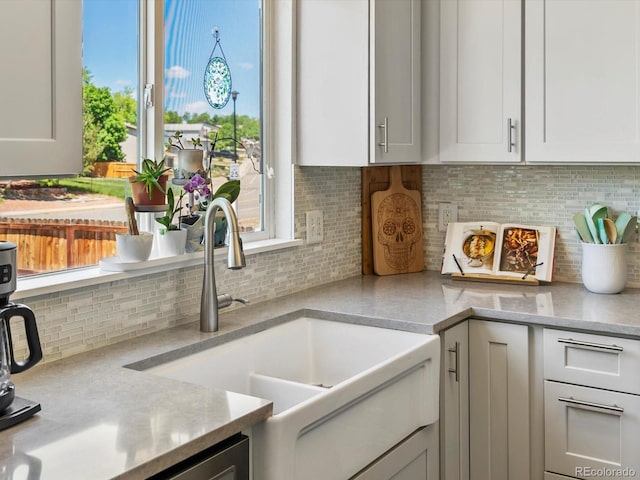 2006 E 97th Ave, Thornton, CO 80229 - kitchen featuring a sink, light countertops, backsplash, and white cabinetry