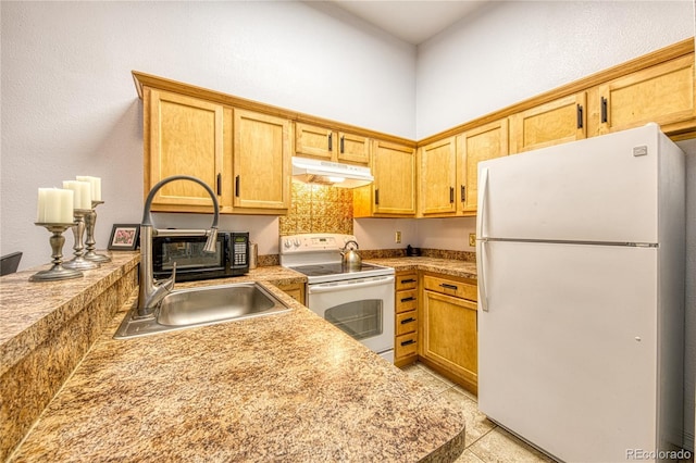 919 S Dawson Way Unit 17, Aurora, CO 80012 - kitchen with white appliances, under cabinet range hood, a sink, and light countertops