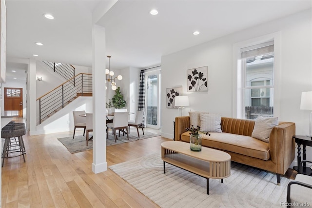 living room featuring an inviting chandelier and light wood-type flooring