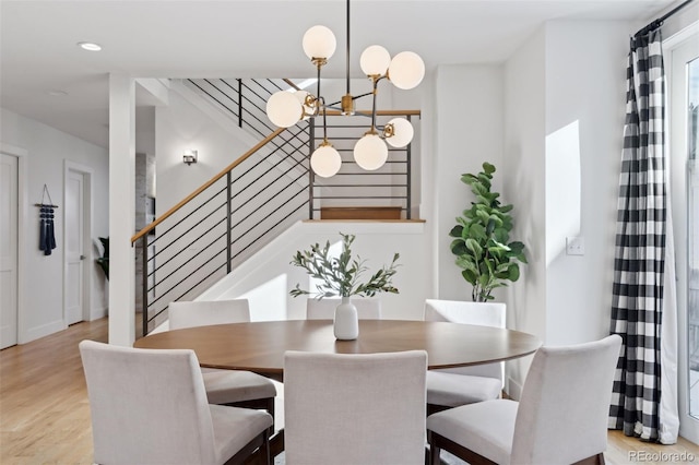 dining area featuring an inviting chandelier and light wood-type flooring