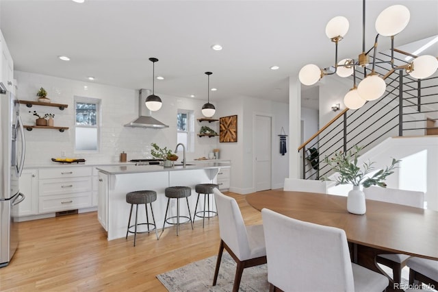 dining room with sink and light hardwood / wood-style flooring