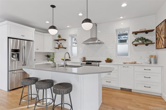 kitchen featuring stainless steel fridge with ice dispenser, sink, white cabinets, and wall chimney exhaust hood