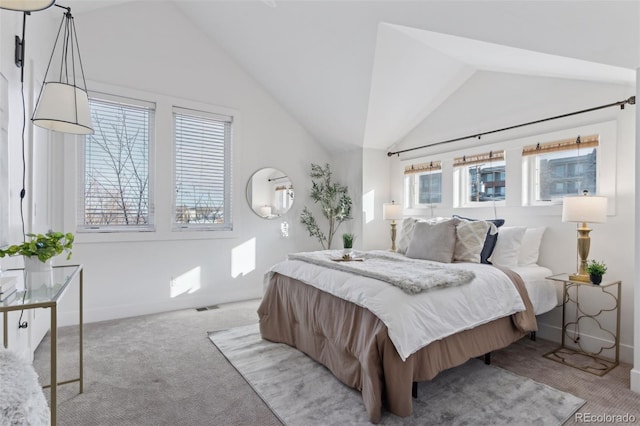 bedroom with vaulted ceiling and light carpet