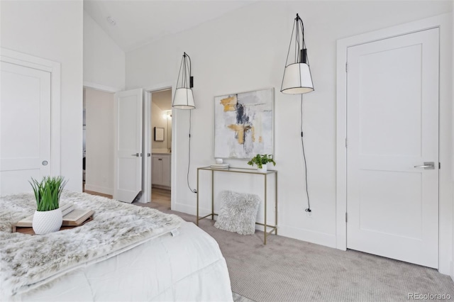 bedroom with light colored carpet and vaulted ceiling