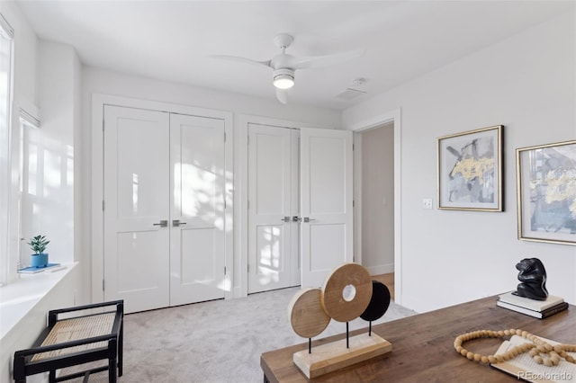 sitting room featuring light colored carpet and ceiling fan