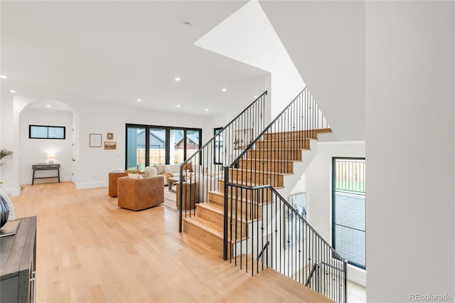 4452 Xavier St, Denver, CO 80212 - stairway featuring arched walkways, wood finished floors, and recessed lighting