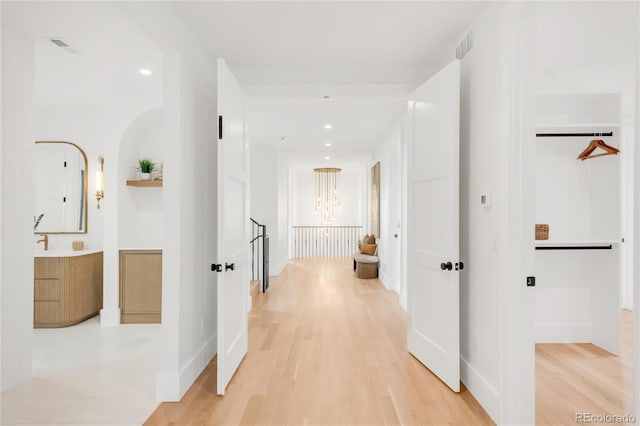 4452 Xavier St, Denver, CO 80212 - hallway featuring light wood-style flooring, a chandelier, and recessed lighting