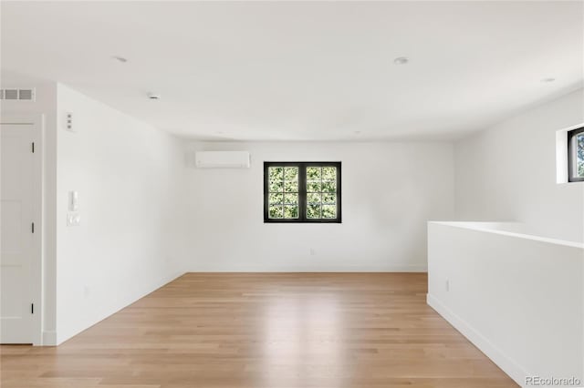 4452 Xavier St, Denver, CO 80212 - empty room with a wall mounted air conditioner and light wood-type flooring