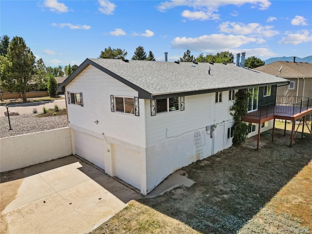 exterior space featuring a wooden deck and a garage