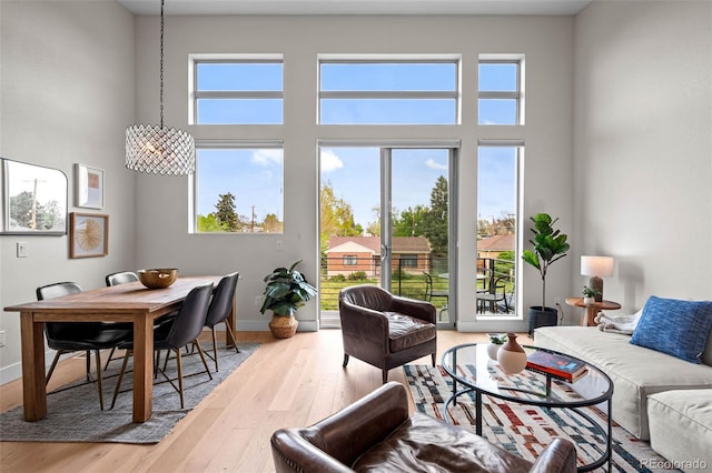 3480 E 31st Ave, Denver, CO 80205 - living room with wood finished floors, baseboards, and a high ceiling
