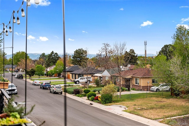 3480 E 31st Ave, Denver, CO 80205 - view of asphalt road featuring a residential view, curbs, sidewalks, and street lighting