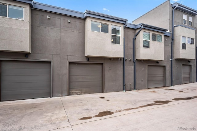 3480 E 31st Ave, Denver, CO 80205 - view of front facade with a garage, driveway, and stucco siding