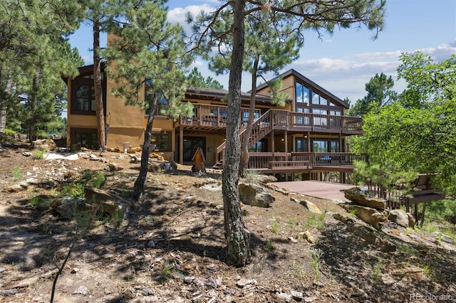 rear view of property featuring a wooden deck