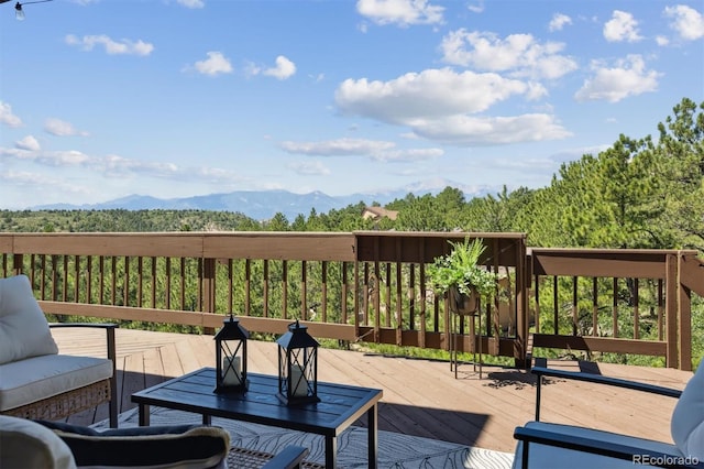 wooden terrace featuring an outdoor hangout area and a mountain view