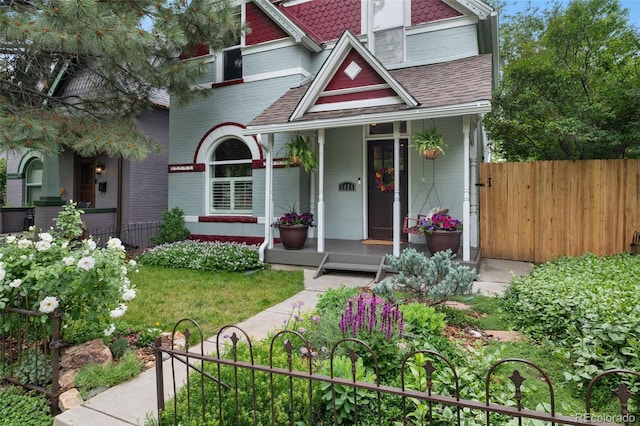 3424 W 31st Ave, Denver, CO 80211 - victorian home with a porch, roof with shingles, and brick siding