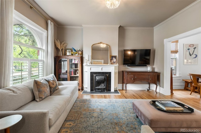 3424 W 31st Ave, Denver, CO 80211 - living room with wood finished floors, ornamental molding, baseboards, and a tile fireplace