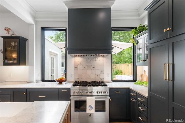 3424 W 31st Ave, Denver, CO 80211 - kitchen with high end appliances, range hood, healthy amount of natural light, light countertops, and crown molding
