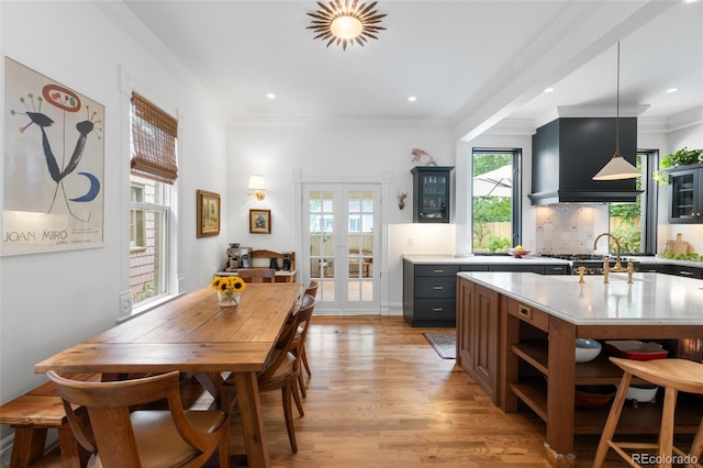 3424 W 31st Ave, Denver, CO 80211 - dining room with french doors, light wood-style floors, crown molding, and recessed lighting