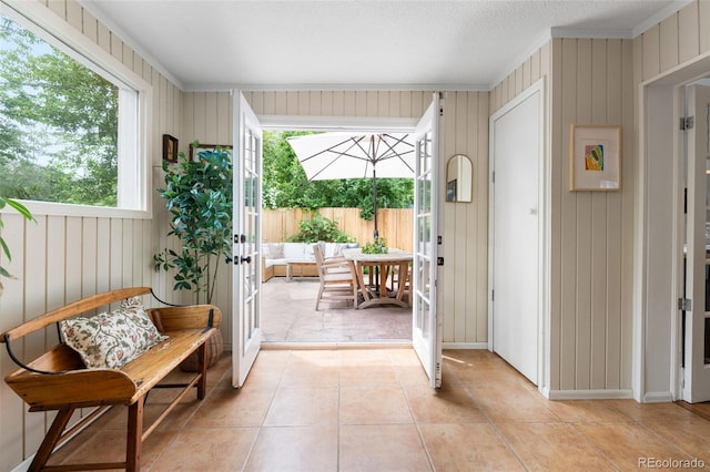 3424 W 31st Ave, Denver, CO 80211 - entrance foyer with ornamental molding, light tile patterned floors, plenty of natural light, french doors, and wood walls