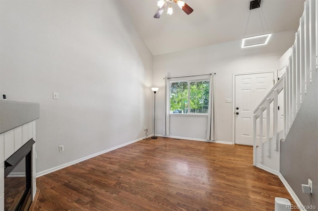 5441 Lynx St, Frederick, CO 80504 - unfurnished living room featuring wood finished floors, stairway, a ceiling fan, a fireplace, and baseboards