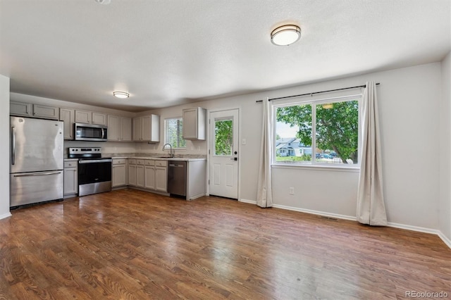 5441 Lynx St, Frederick, CO 80504 - kitchen with appliances with stainless steel finishes, light countertops, gray cabinetry, and baseboards
