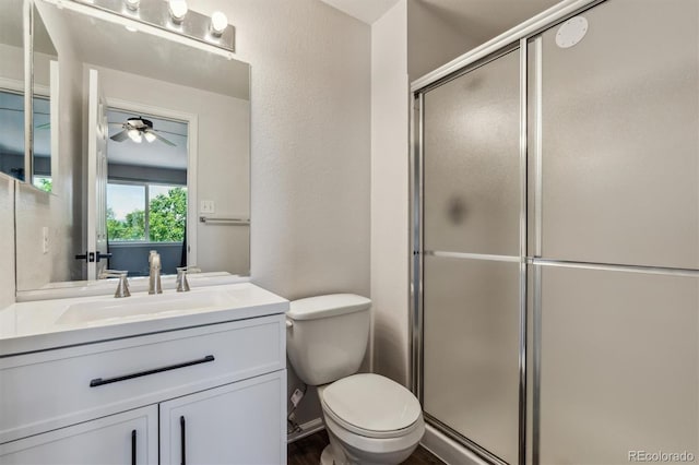 5441 Lynx St, Frederick, CO 80504 - bathroom with a stall shower, toilet, ceiling fan, and vanity