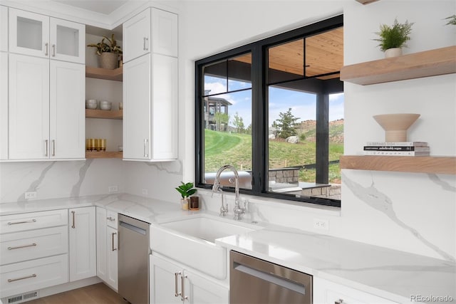 kitchen with dishwasher, open shelves, a sink, and white cabinets