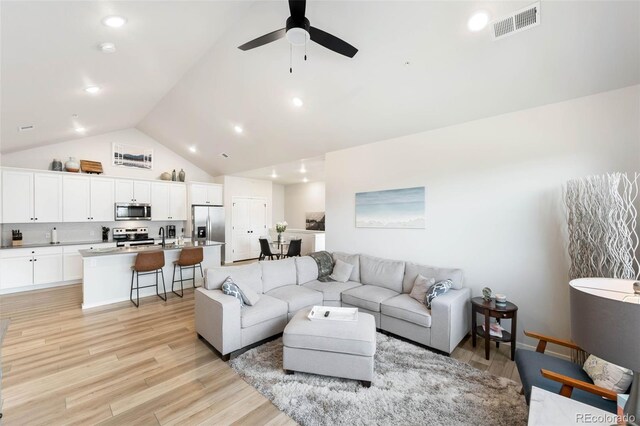 2078 Autumn Moon Dr Unit 3, Windsor, CO 80550 - living room featuring high vaulted ceiling, light wood-style flooring, ceiling fan, and recessed lighting