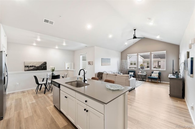 2078 Autumn Moon Dr Unit 3, Windsor, CO 80550 - kitchen featuring appliances with stainless steel finishes, ceiling fan, light wood finished floors, white cabinetry, and vaulted ceiling