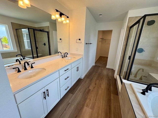 283 Wooten Ave, Brighton, CO 80601 - bathroom with double vanity, a shower stall, a garden tub, and a walk in closet