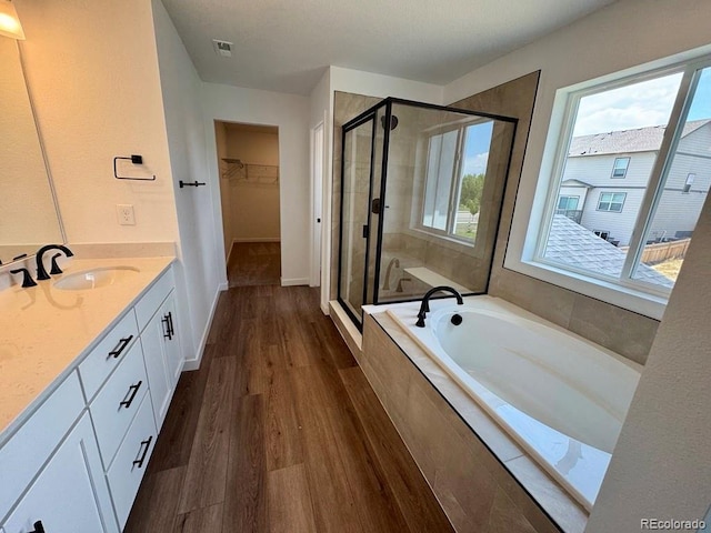 283 Wooten Ave, Brighton, CO 80601 - bathroom featuring a shower stall, healthy amount of natural light, a bath, and vanity