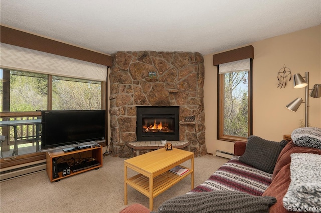 300 Sterling Way Unit 3, Fraser, CO 80442 - carpeted living area featuring a baseboard radiator and a stone fireplace