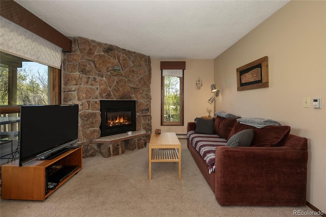 300 Sterling Way Unit 3, Fraser, CO 80442 - carpeted living area with a fireplace, a textured ceiling, and a baseboard radiator