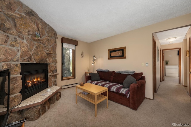 300 Sterling Way Unit 3, Fraser, CO 80442 - living room featuring a baseboard heating unit, carpet flooring, a fireplace, and a textured ceiling