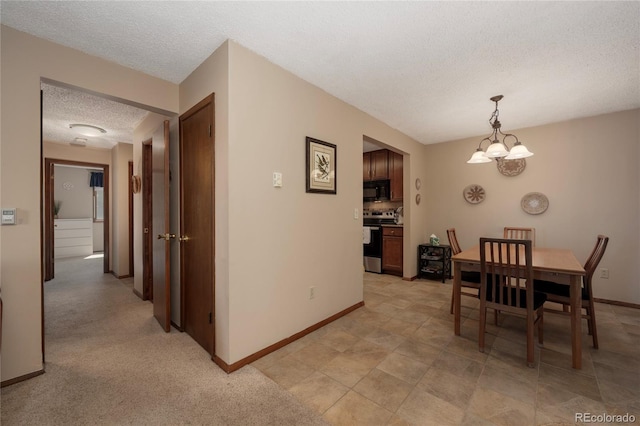 300 Sterling Way Unit 3, Fraser, CO 80442 - dining area featuring a textured ceiling, a chandelier, and baseboards