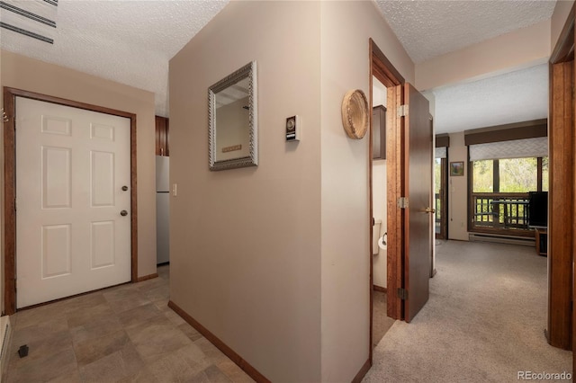 300 Sterling Way Unit 3, Fraser, CO 80442 - hall featuring a textured ceiling, baseboards, and baseboard heating