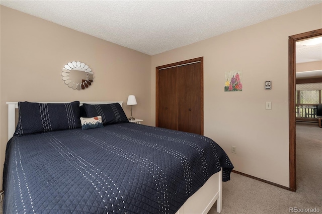 300 Sterling Way Unit 3, Fraser, CO 80442 - bedroom featuring carpet flooring, a closet, a textured ceiling, and baseboards