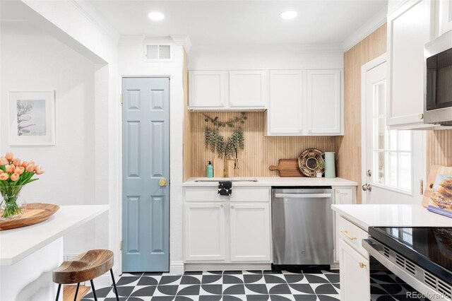 2313 S Race St Unit A, Denver, CO 80210 - kitchen with appliances with stainless steel finishes, a sink, tile patterned floors, light countertops, and white cabinetry