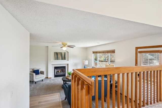 hallway with a textured ceiling and wood finished floors