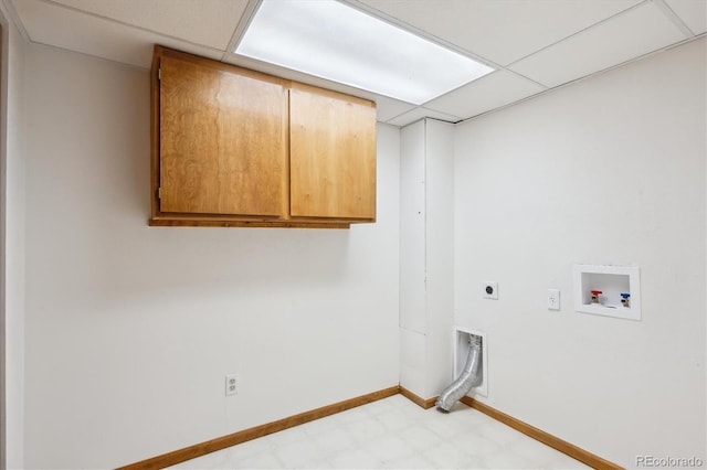 washroom with electric dryer hookup, cabinet space, baseboards, hookup for a washing machine, and light floors