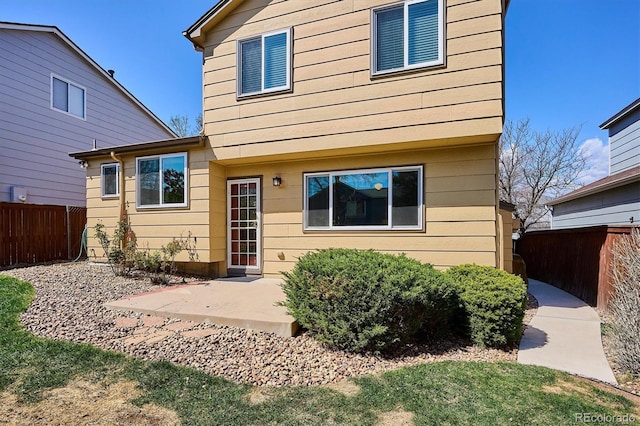 back of house with fence and a patio area