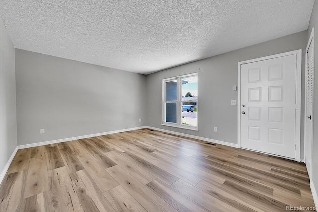 19155 E Kansas Dr, Aurora, CO 80017 - unfurnished room with a textured ceiling, light wood-style floors, and baseboards
