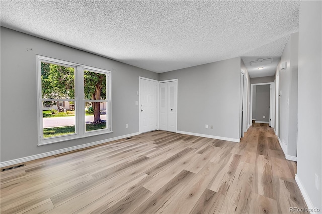 19155 E Kansas Dr, Aurora, CO 80017 - unfurnished room featuring a textured ceiling, light wood-style flooring, and baseboards