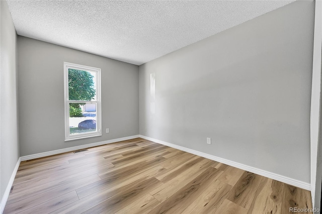 19155 E Kansas Dr, Aurora, CO 80017 - spare room featuring light wood finished floors, a textured ceiling, and baseboards