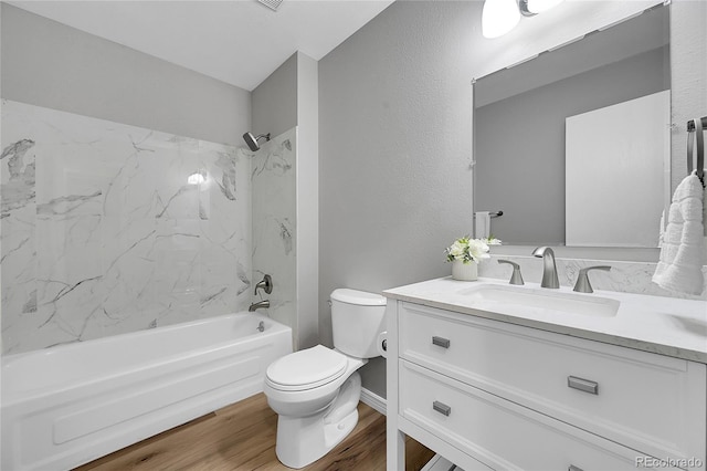 19155 E Kansas Dr, Aurora, CO 80017 - full bath featuring toilet, vanity,  shower combination, wood finished floors, and a textured wall