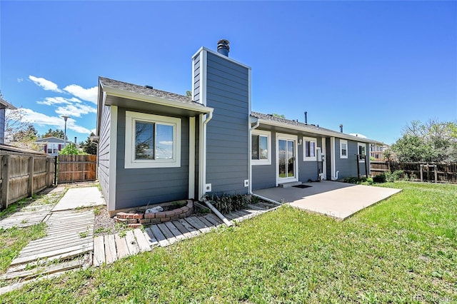 19155 E Kansas Dr, Aurora, CO 80017 - back of property featuring a patio area and a chimney