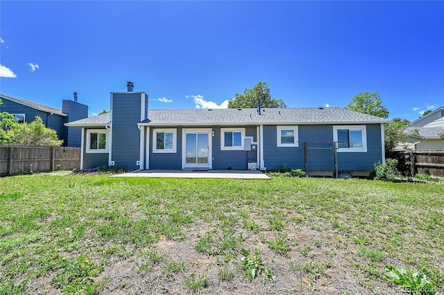 19155 E Kansas Dr, Aurora, CO 80017 - rear view of house featuring a patio and a chimney